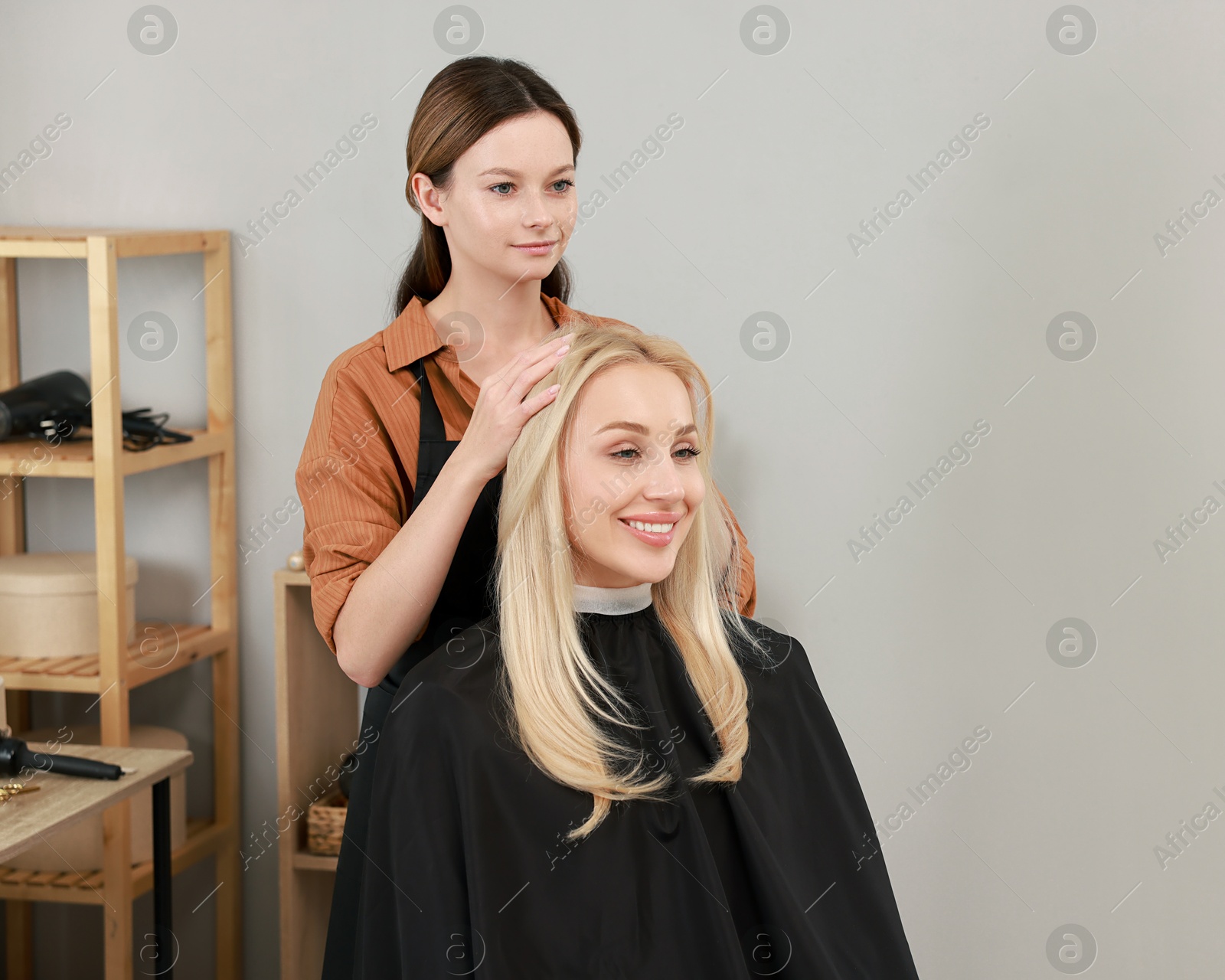 Photo of Hair cutting. Professional hairdresser working with client in salon, space for text