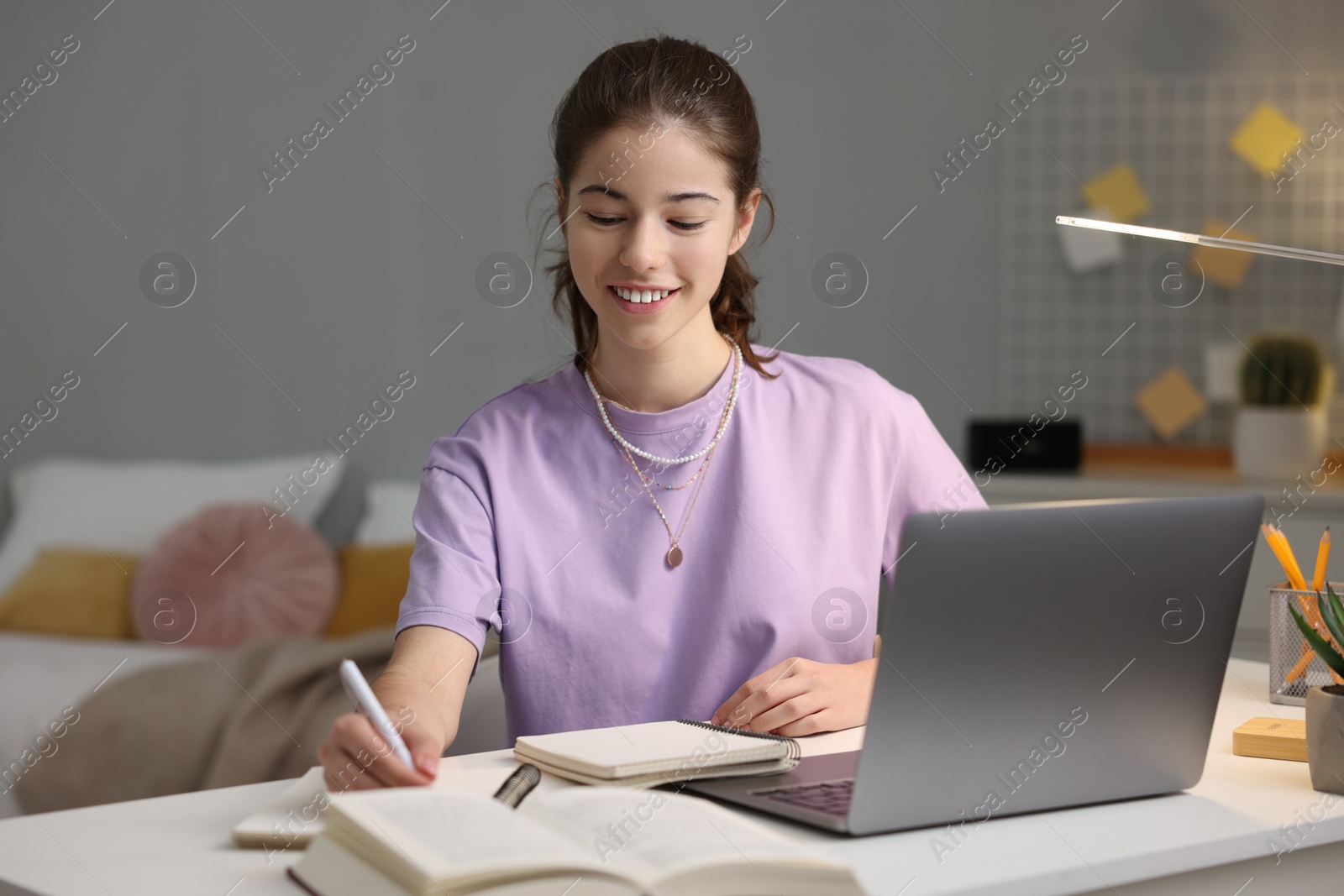 Photo of Student preparing for exam at table indoors