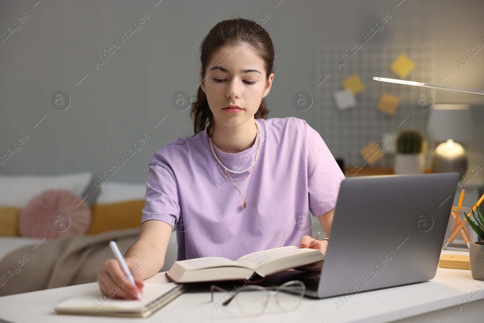 Photo of Student preparing for exam at table indoors