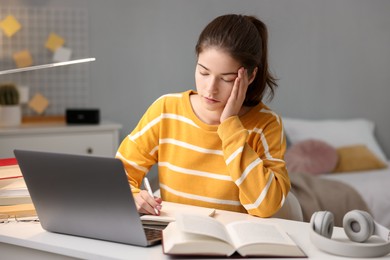 Photo of Preparing for exam. Tired student sleeping at table indoors