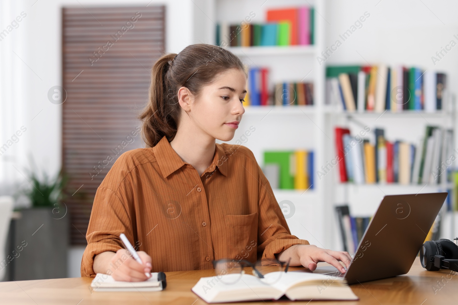 Photo of Student preparing for exam at table indoors