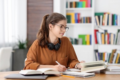 Photo of Student preparing for exam at table indoors