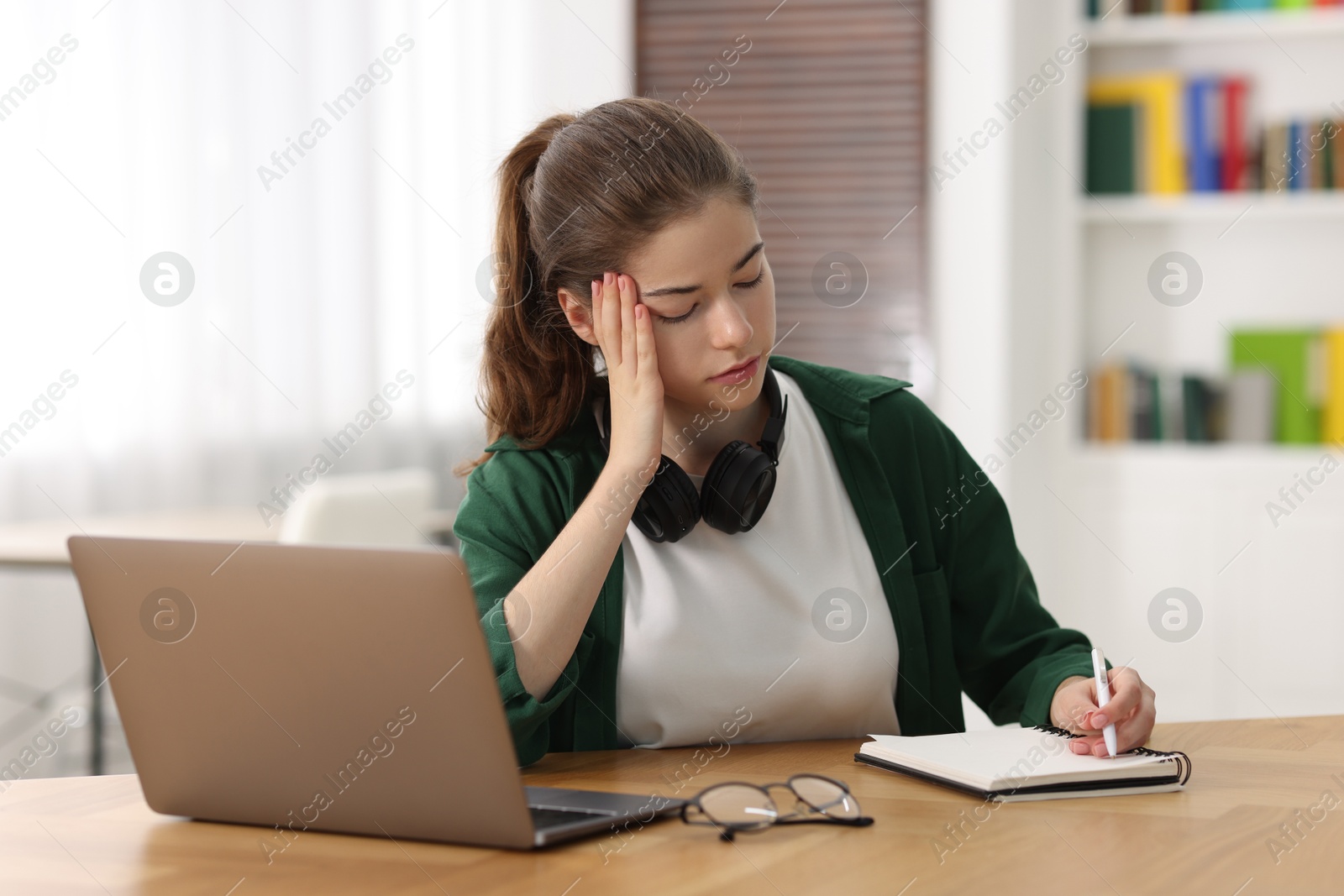 Photo of Student preparing for exam at table indoors