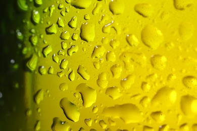 Photo of Water drops on color glass surface, macro view