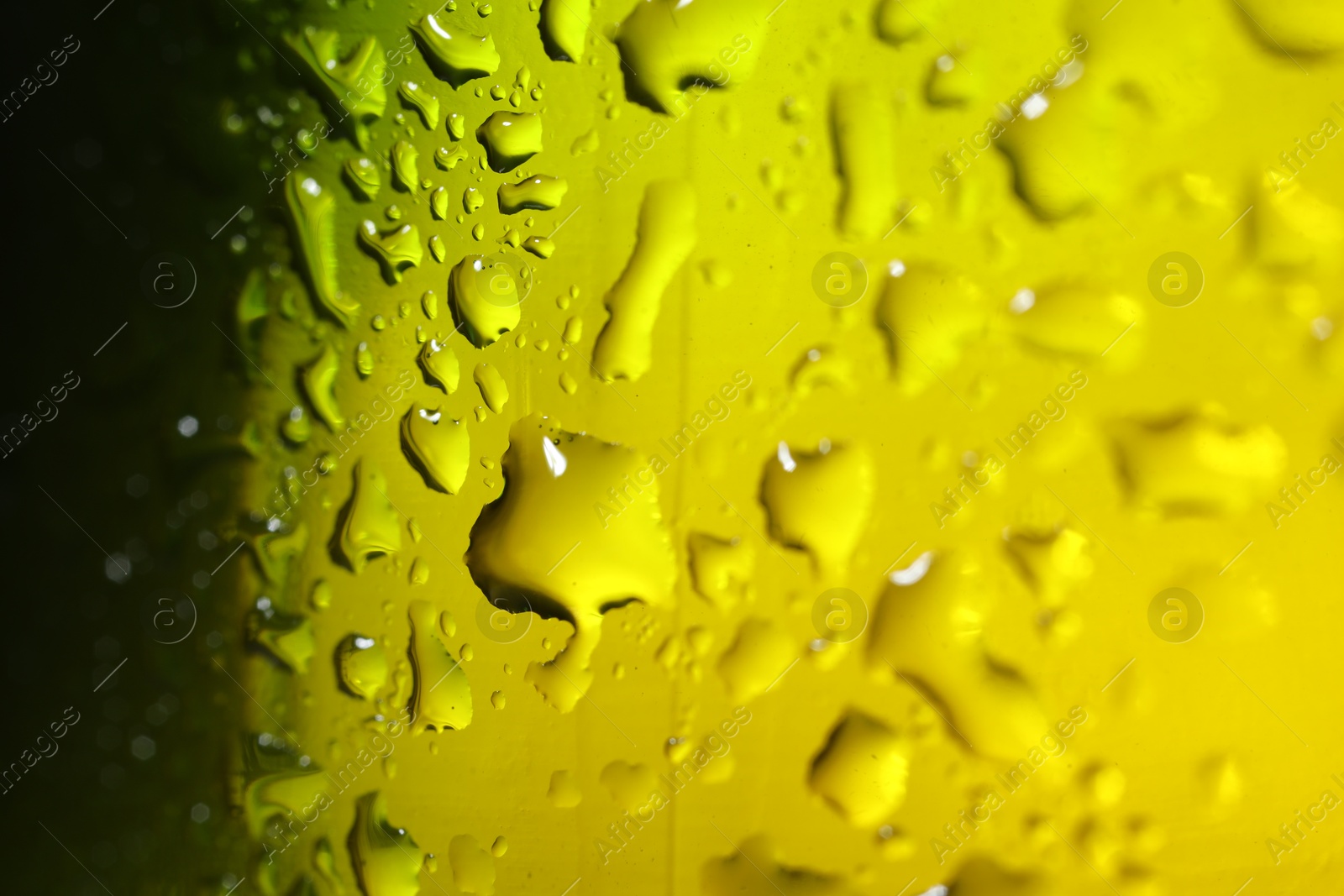 Photo of Water drops on color glass surface, macro view