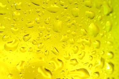 Photo of Water drops on color glass surface, macro view