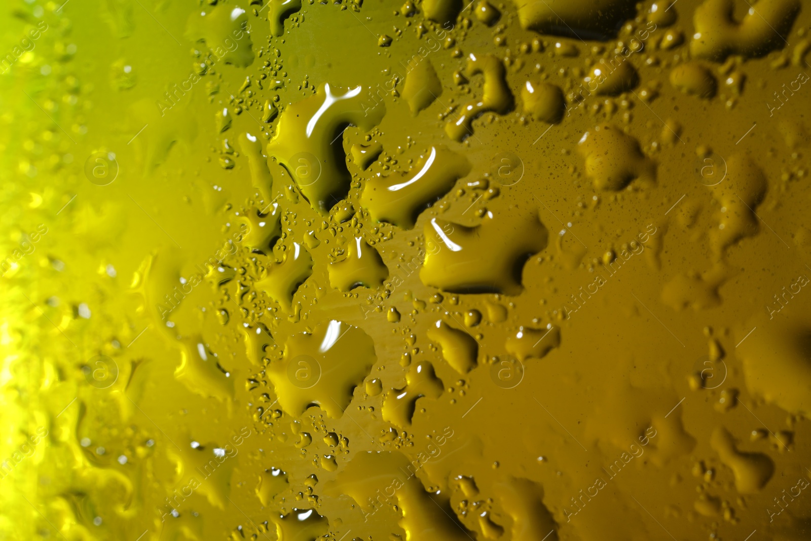 Photo of Water drops on color glass surface, macro view