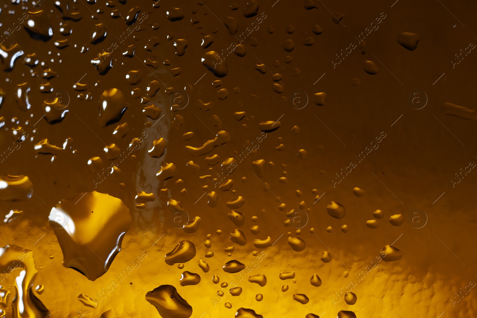 Photo of Water drops on color glass surface, macro view