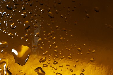 Water drops on color glass surface, macro view