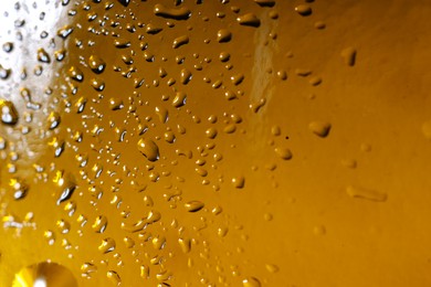 Photo of Water drops on color glass surface, macro view