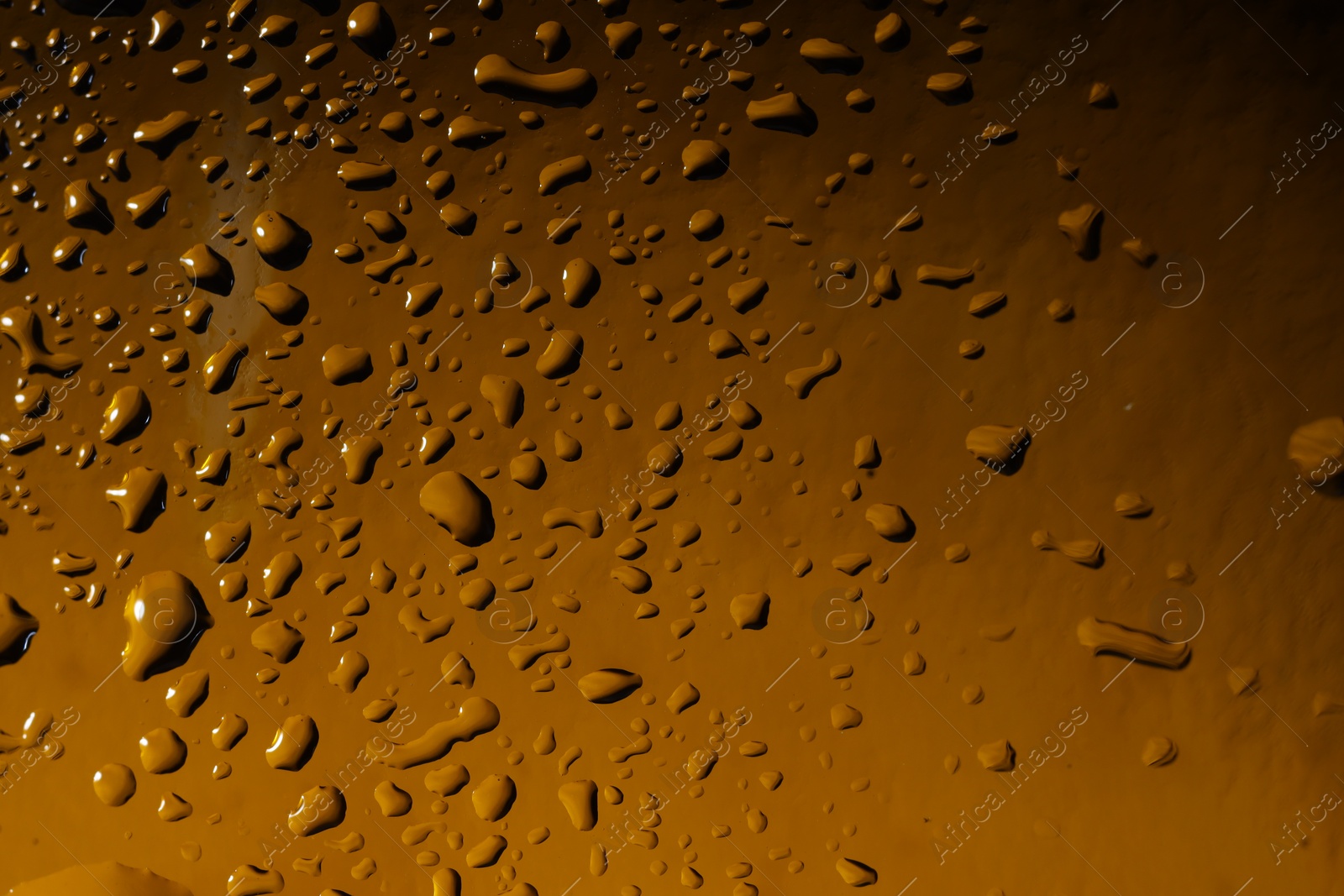 Photo of Water drops on color glass surface, macro view