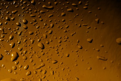 Photo of Water drops on color glass surface, macro view