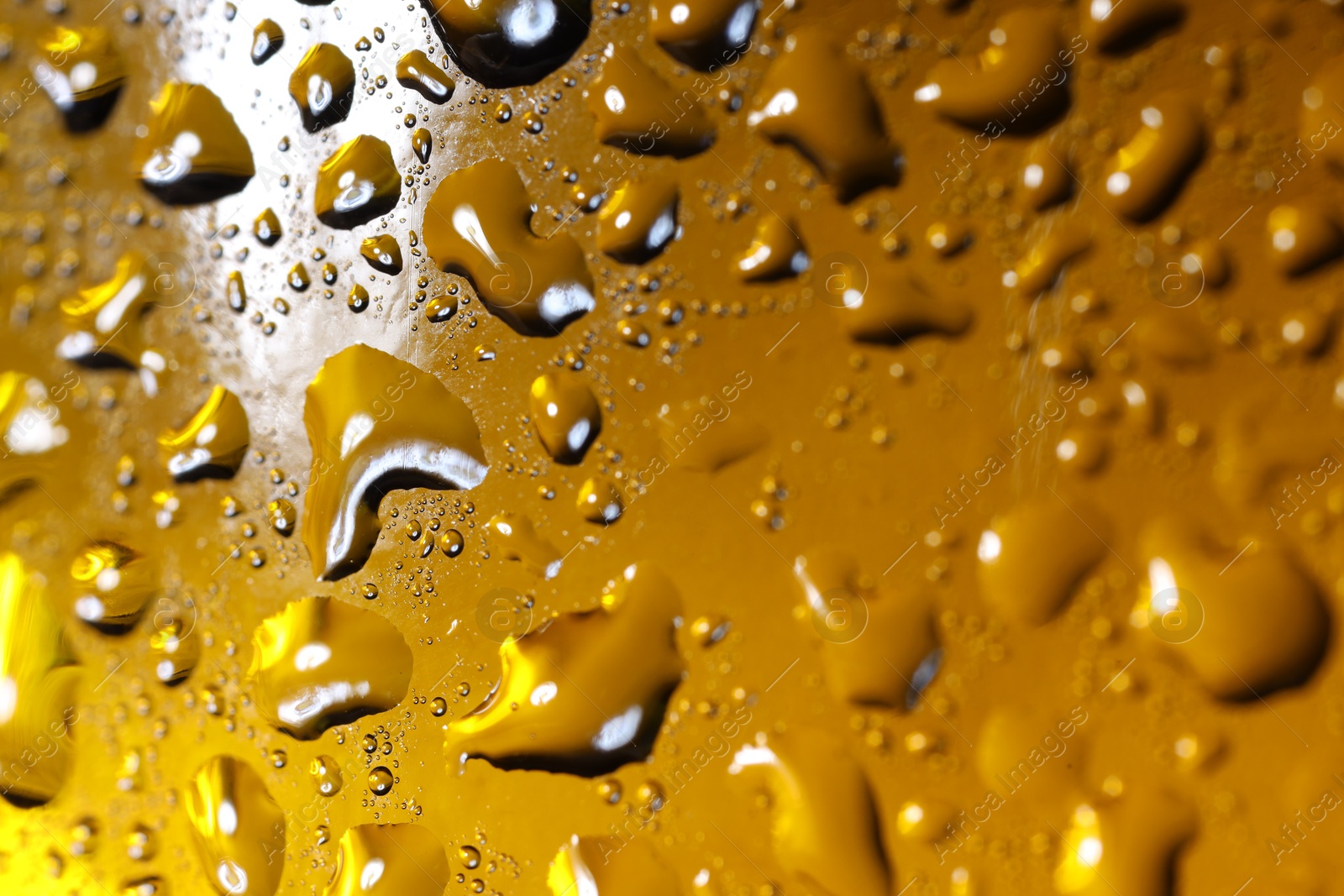 Photo of Water drops on color glass surface, macro view