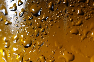 Photo of Water drops on color glass surface, macro view