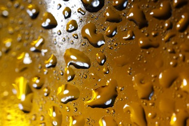 Photo of Water drops on color glass surface, macro view