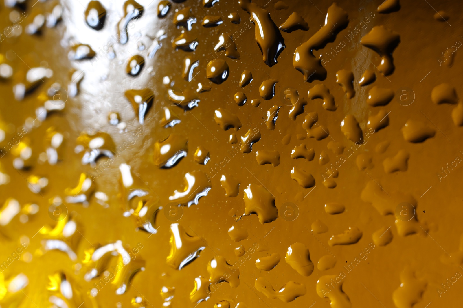 Photo of Water drops on color glass surface, macro view