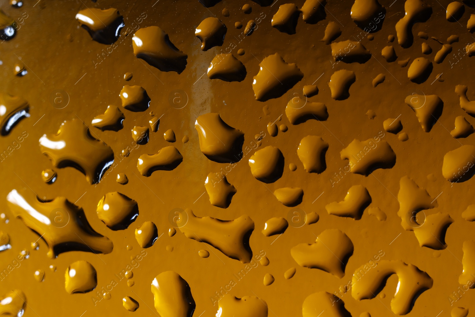 Photo of Water drops on color glass surface, macro view