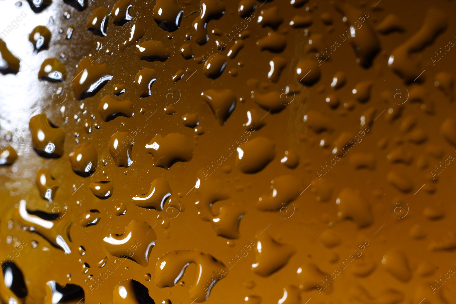 Photo of Water drops on color glass surface, macro view