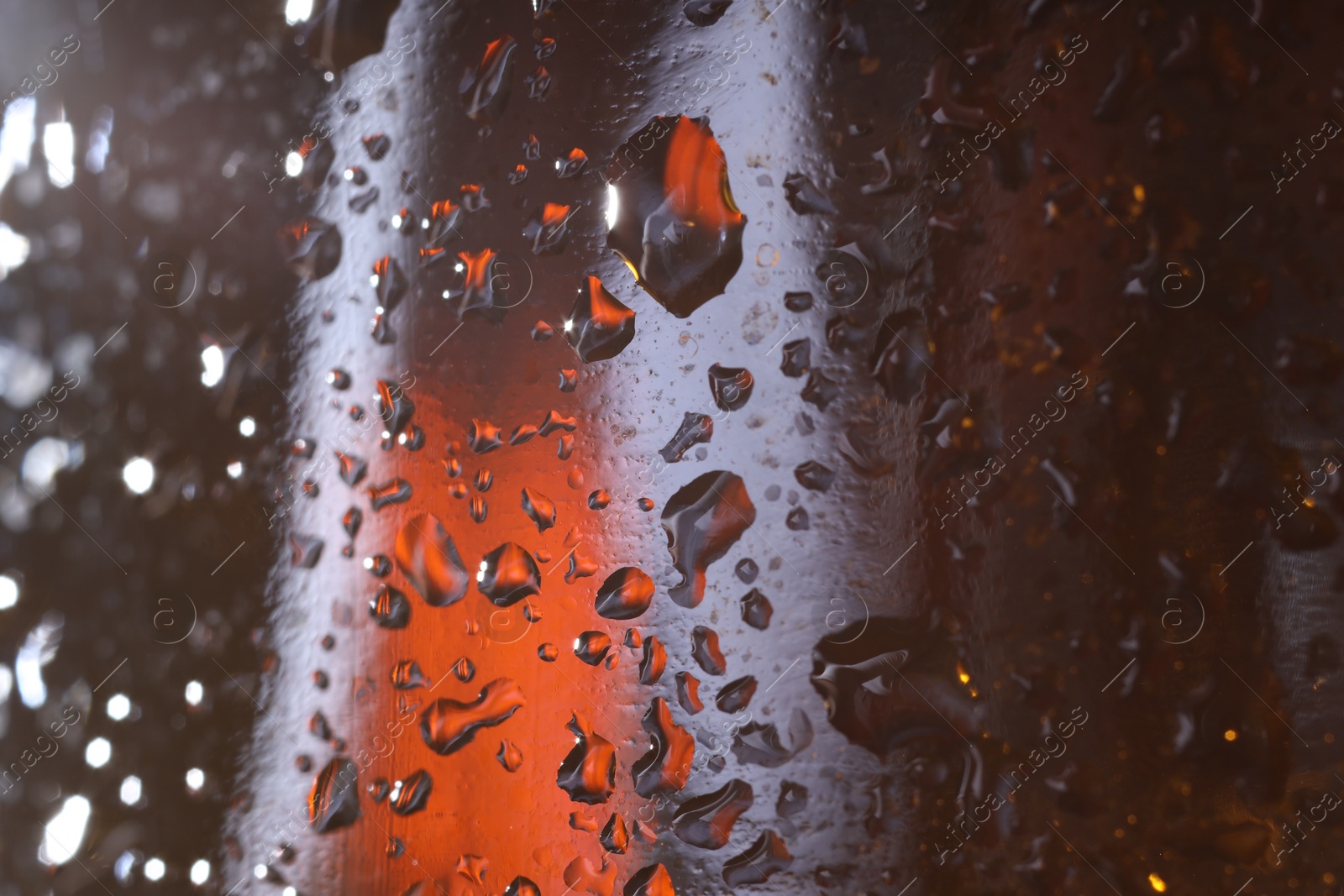 Photo of Water drops on color glass surface, macro view