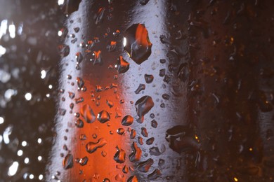 Photo of Water drops on color glass surface, macro view