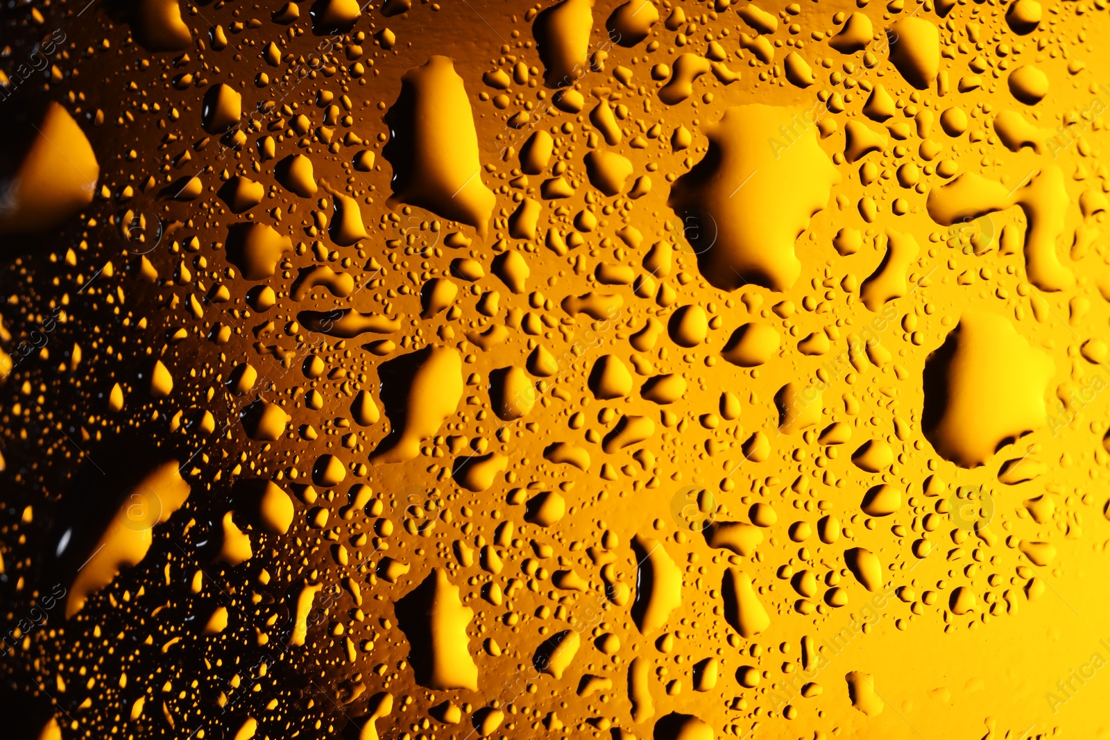 Photo of Water drops on color glass surface, macro view