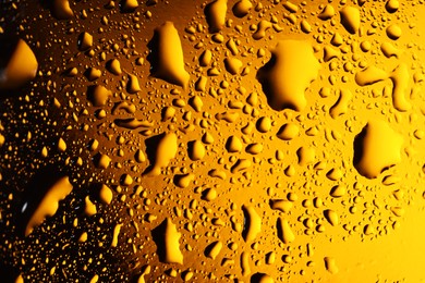 Photo of Water drops on color glass surface, macro view