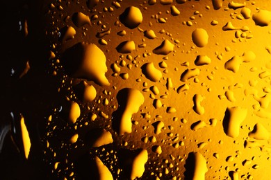 Photo of Water drops on color glass surface, macro view