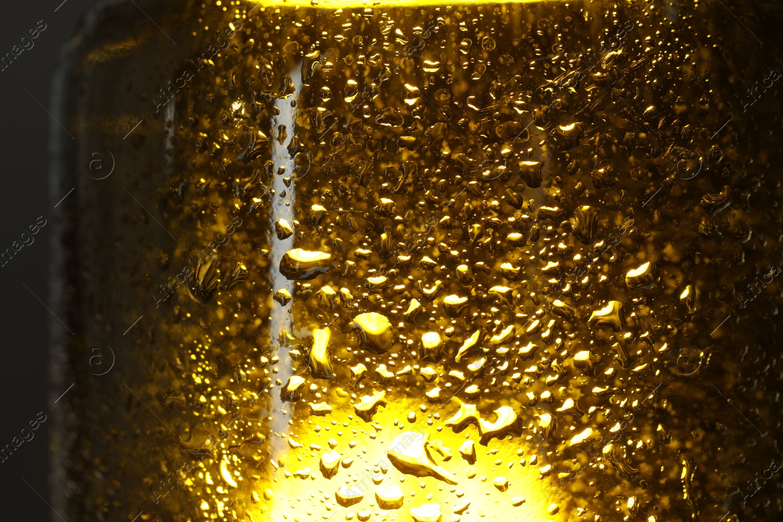 Photo of Glass bottle with condensation drops, macro view