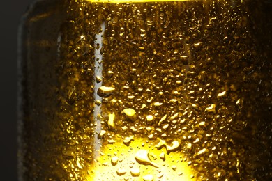 Photo of Glass bottle with condensation drops, macro view