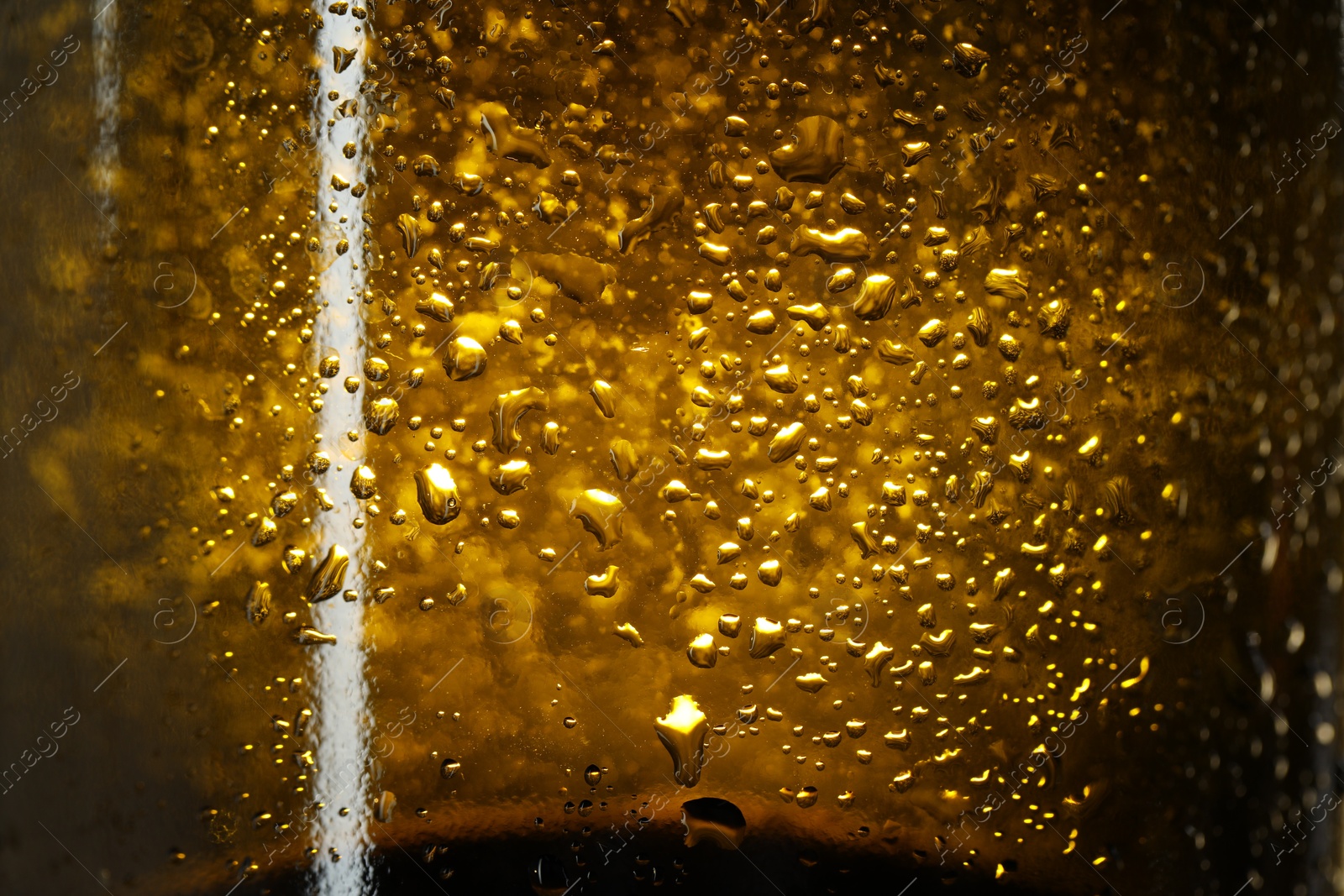 Photo of Glass bottle with condensation drops, macro view