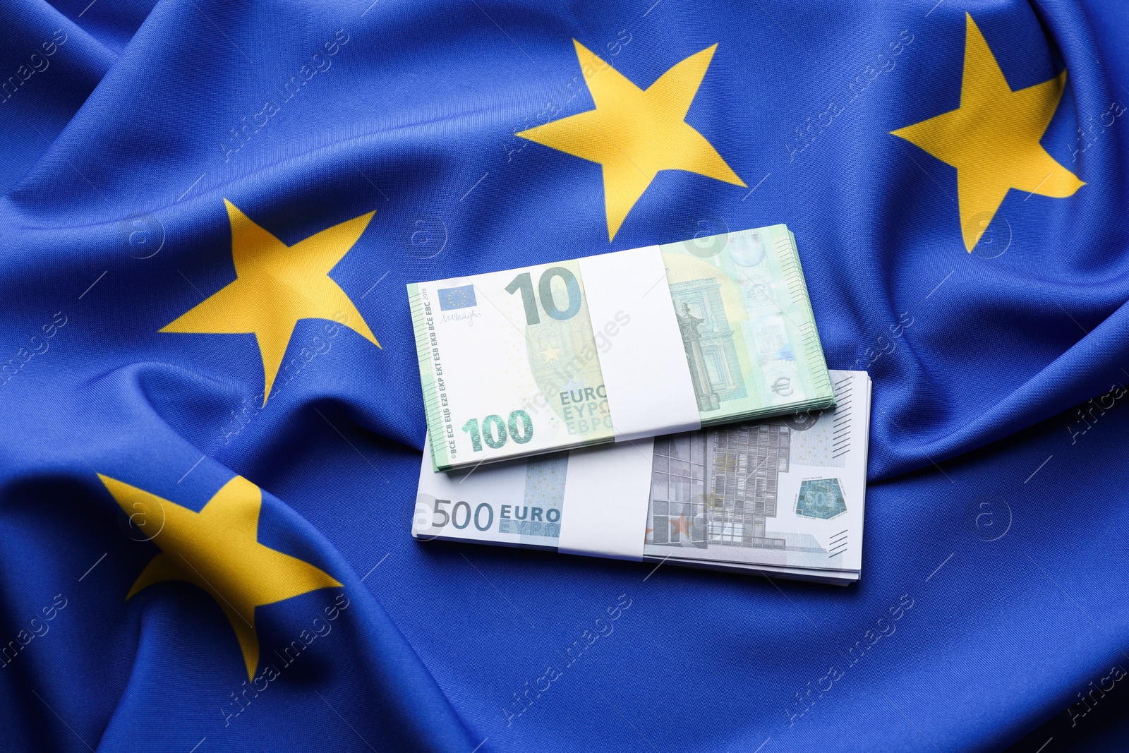 Photo of Euro banknotes on European Union flag, top view