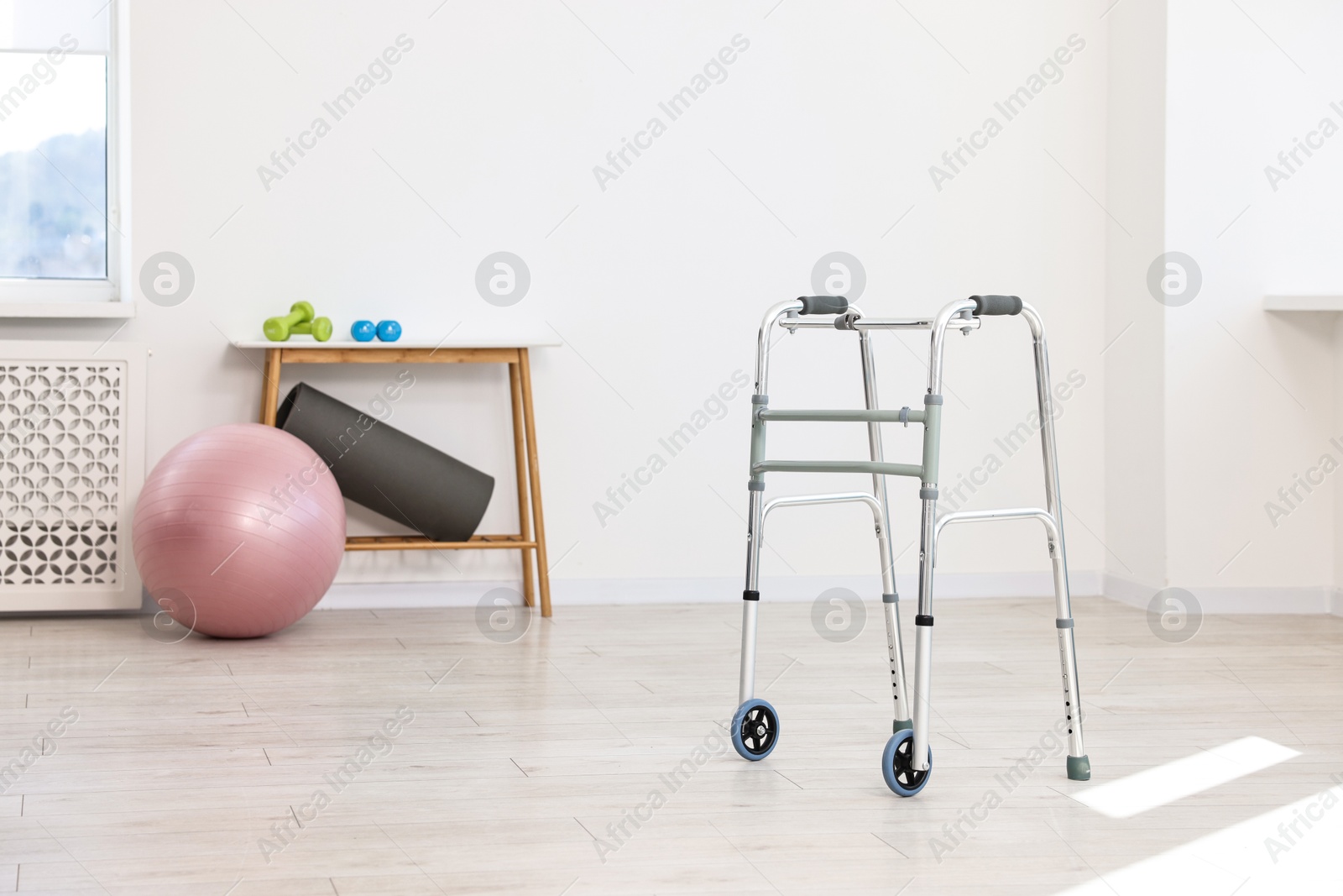 Photo of Metal walking frame in room. Medical equipment