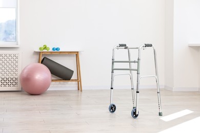 Metal walking frame in room. Medical equipment