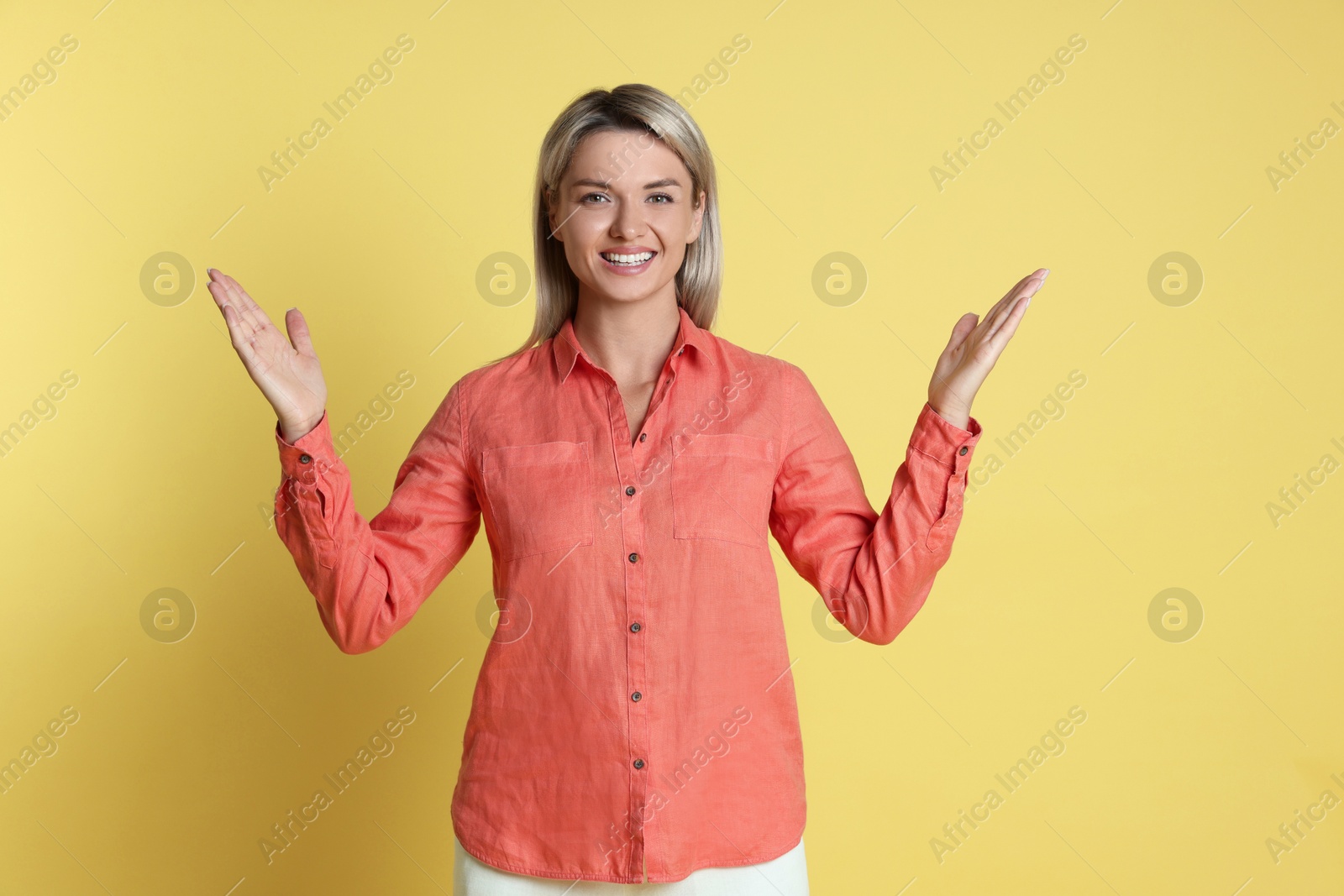 Photo of Portrait of happy winner on yellow background