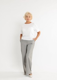 Photo of Full length portrait of beautiful senior woman on white background