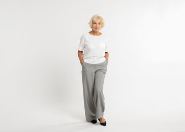 Photo of Full length portrait of beautiful senior woman on white background, space for text