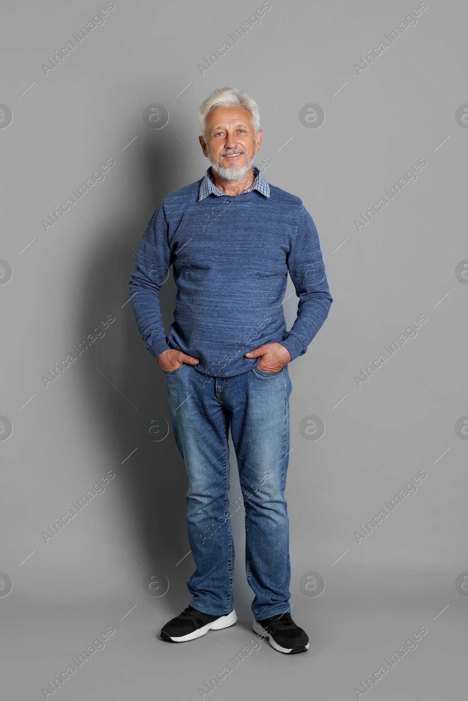 Photo of Full length portrait of senior man on grey background