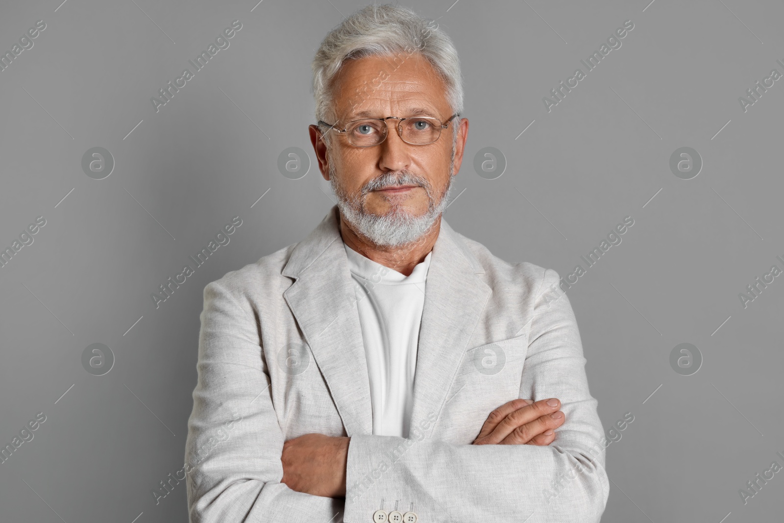 Photo of Portrait of senior man on grey background