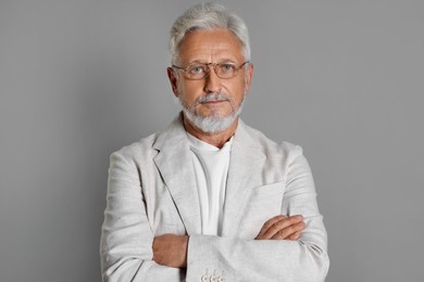 Photo of Portrait of senior man on grey background