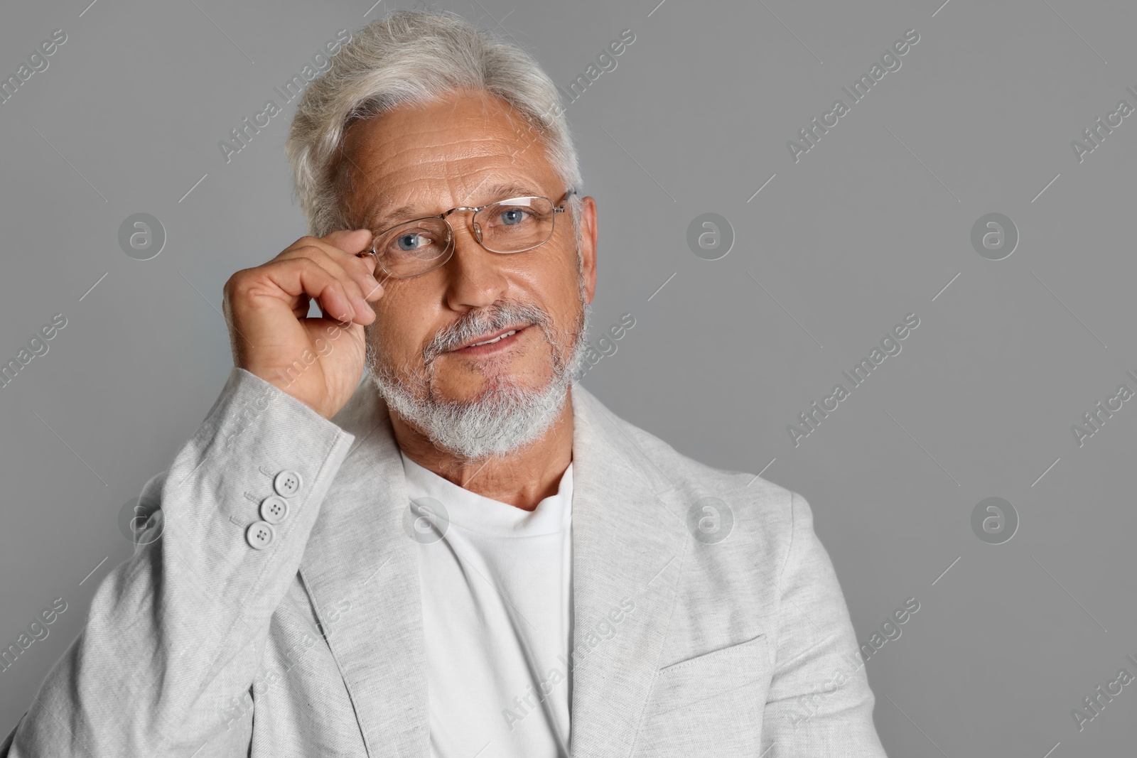 Photo of Portrait of senior man on grey background