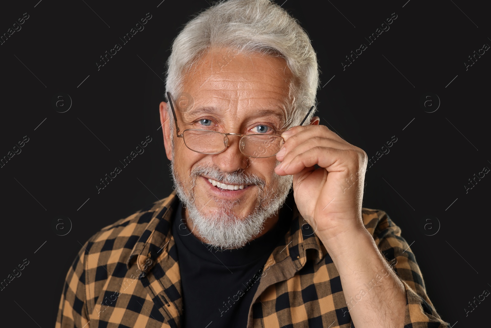 Photo of Portrait of senior man on black background