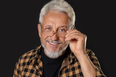 Photo of Portrait of senior man on black background