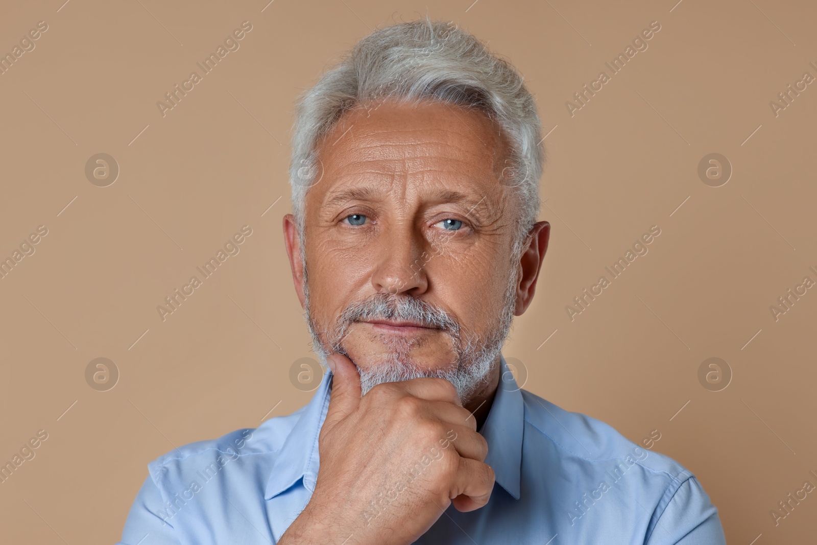 Photo of Portrait of senior man on beige background