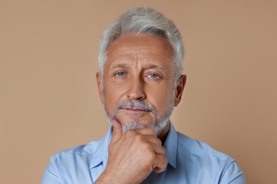 Photo of Portrait of senior man on beige background