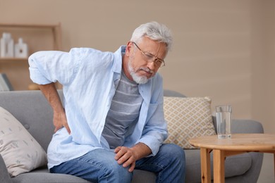 Photo of Senior man suffering from backache at home