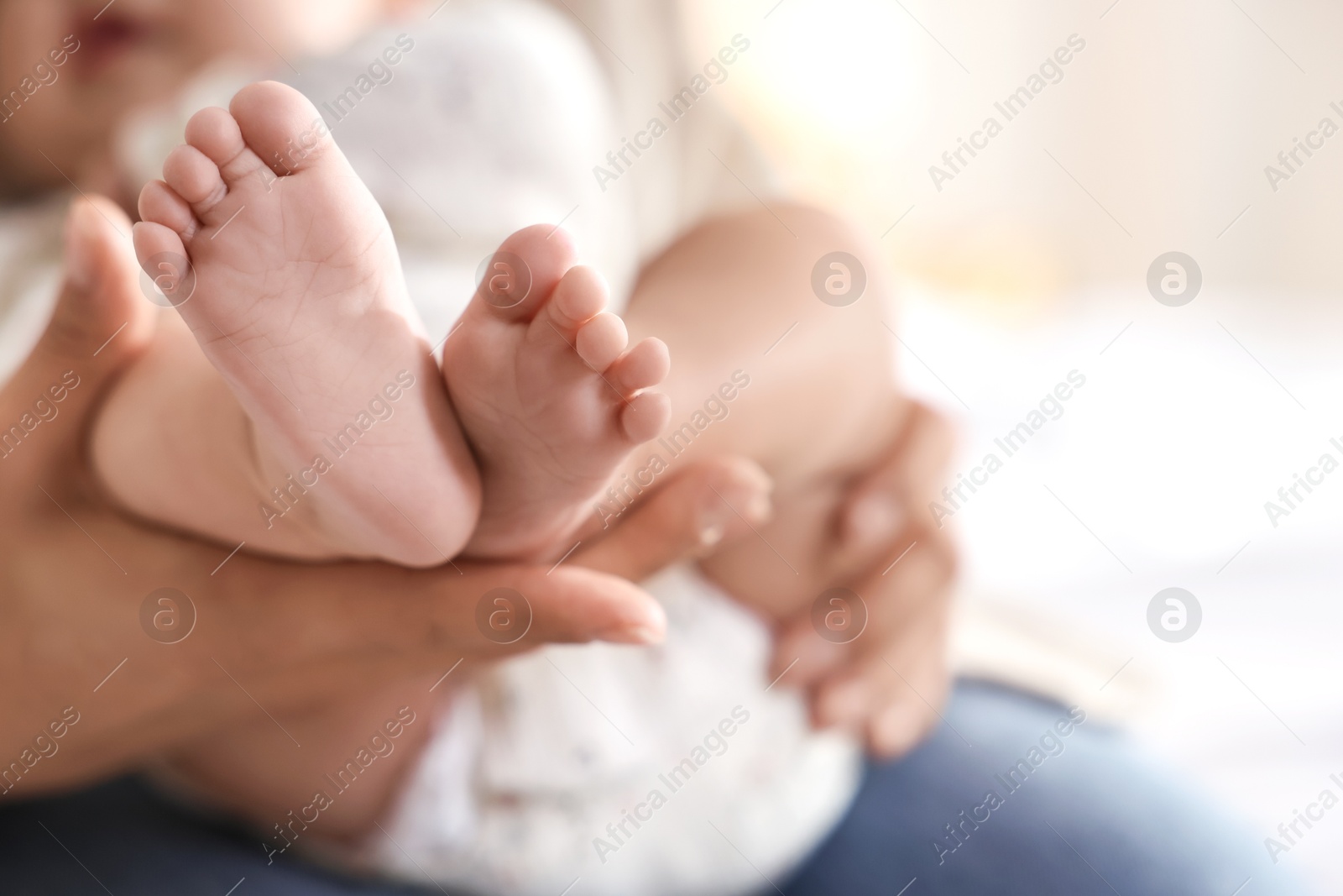 Photo of Mother with her cute little baby at home, closeup. Space for text