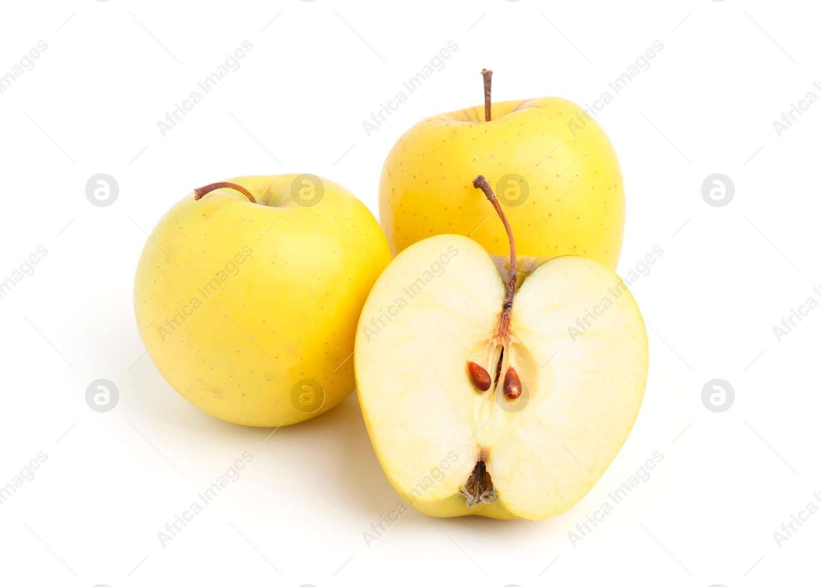 Photo of Whole and cut ripe yellow apples isolated on white