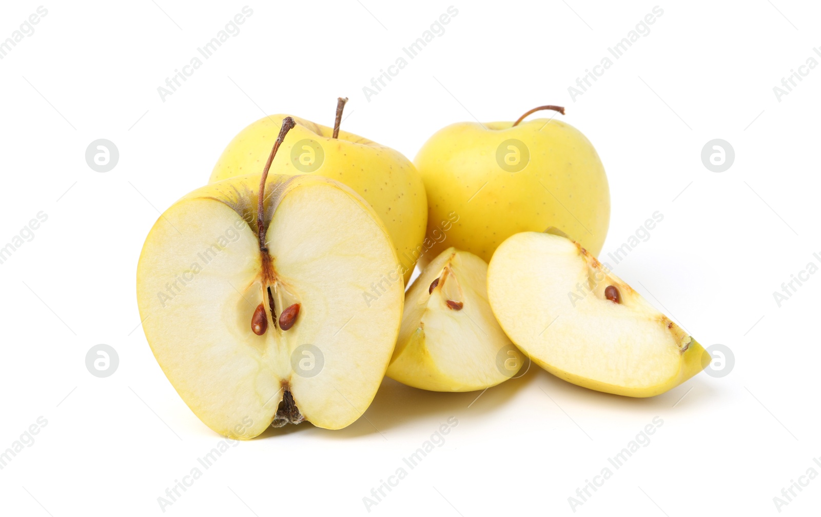 Photo of Whole and cut ripe yellow apples isolated on white