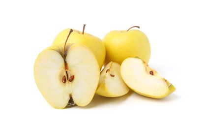 Whole and cut ripe yellow apples isolated on white