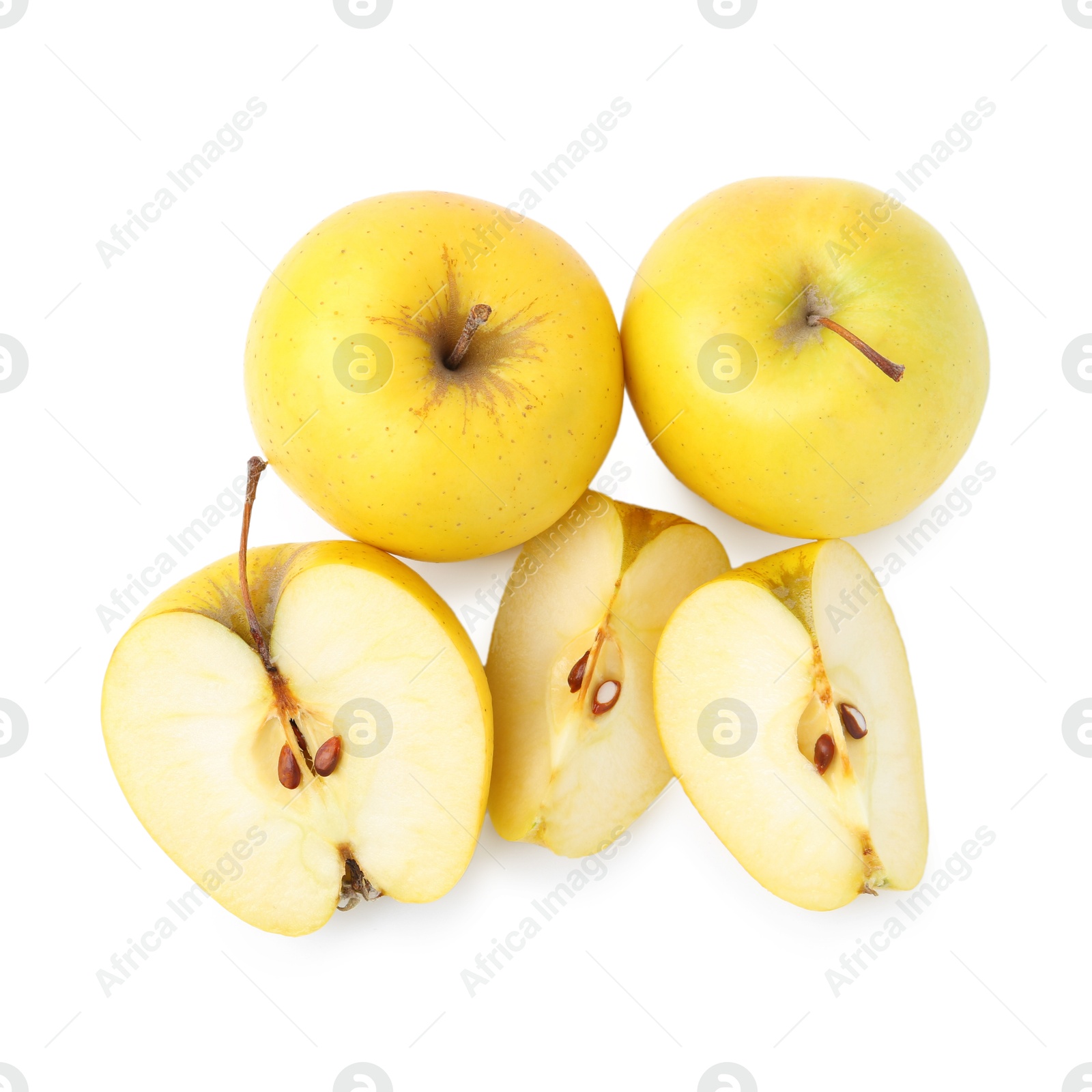 Photo of Whole and cut ripe yellow apples isolated on white, top view